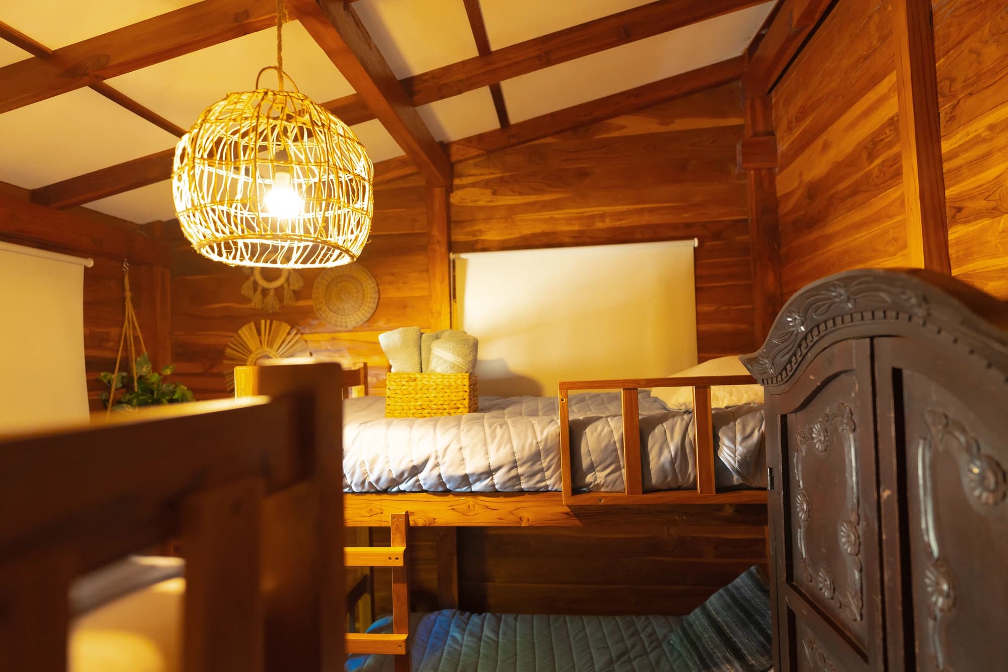 Bunk room lit by a woven lamp